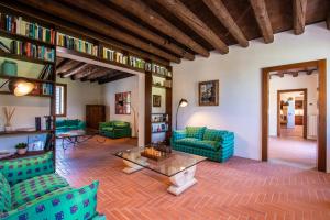 a living room with blue couches and a table at Il Salice Country Luxury in Due Carrare