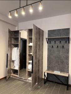 a dressing room with wooden shelves and a mirror at Berloga Hotel in Pavlodar