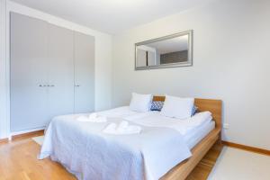 a bedroom with a bed with two towels on it at Aurora Family Suite in Rovaniemi