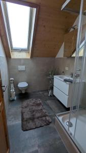 a bathroom with a sink and a toilet and a window at NEU Apartment Antonia - Ferienglück Allgäu in Lachen