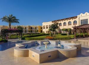 a courtyard with a fountain in the middle of a building at Charmillion Club Resort in Sharm El Sheikh