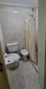 a bathroom with a toilet and a sink at Hospedaje Costanera del Sol in La Adela +19 photos