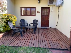 two chairs and a table on a wooden deck at Terrazas de Colón in Colón