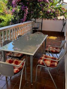 a table and chairs on a patio with flowers at Apartment Viktor in Sali