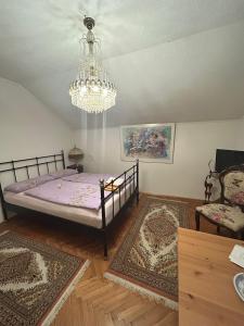 una camera da letto con un letto e un lampadario di Stara Ruža a Gračanica