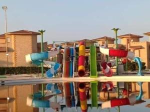 a water park with a colorful water slide at Spacious Villa with Pool and Sea View in Dawwār ‘Abd Allāh