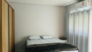 a small bedroom with a bed in a room at Pousada Ventos in Chapada dos Guimarães