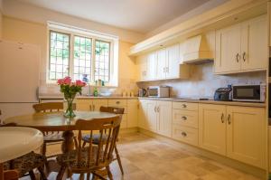 a kitchen with a table and a dining room at Bossington Bunkhouse in Minehead