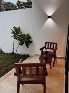 a bench and a chair on a patio at Muunyal Naj in Valladolid