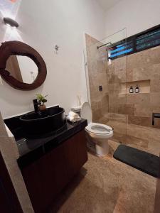 a bathroom with a sink and a toilet and a mirror at Muunyal Naj in Valladolid