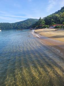 a view of a beach with a sandy shoreline at Suíte Cambucá in Praia do Bananal