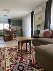 a living room with a couch and a table at Rizling Vendégház in Balatonrendes +17 photos