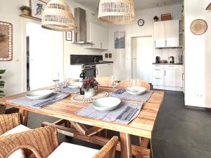 a dining room with a wooden table with chairs at COZEE - The Oasis in Kaiserslautern
