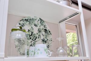 a shelf with glass jars and a mirror at Dream Rome Aurelia apt pool&parking in Rome +20 photos