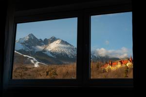 a window with a view of a mountain at Hotel Tulipan in Tatranská Lomnica