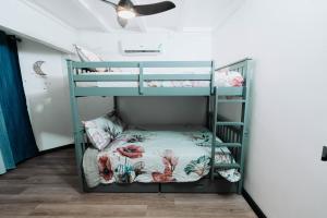 two bunk beds in a room with a ceiling at Aintree Bungalow in Portmore