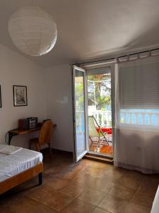 a bedroom with a bed and a sliding glass door at Apartment Viktor in Sali