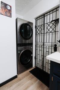 a laundry room with two washer and dryer at Aintree Bungalow in Portmore +39 photos