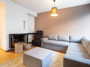 a living room with a couch and a fireplace at Aurora Family Suite in Rovaniemi
