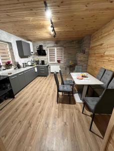 a kitchen and dining room with a table and chairs at mountain house in Skhidnitsa