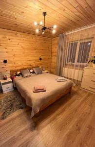 a bedroom with a bed in a wooden room at mountain house in Skhidnitsa