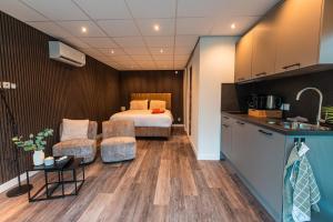 a kitchen and a bedroom with a bed in a room at Tiny Boat House #6 in Garnwerd