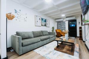 a living room with a couch and a table at Aintree Bungalow in Portmore