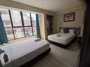 En eller flere senge i et værelse på Hotel Konford Cañete