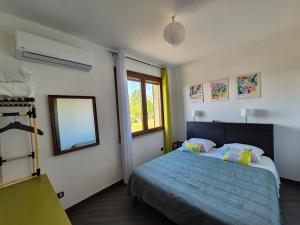 a bedroom with a blue bed and a window at Casa Scova, entire apartment in Garlasco