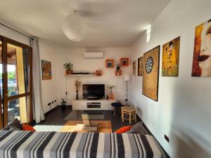 a bedroom with a bed and a tv in a room at Casa Scova, entire apartment in Garlasco