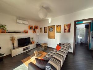 a living room with a couch and a flat screen tv at Casa Scova, entire apartment in Garlasco