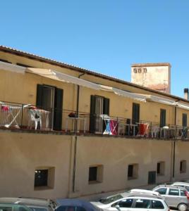 a building with cars parked on the balcony at Monolocale La torre in Rio Marina +5 photos