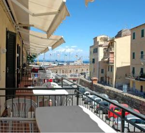 a balcony with tables and a view of a city at Monolocale La torre in Rio Marina