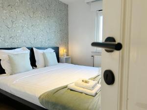 a bedroom with a bed with two towels on it at Villa Duin 33 in Westende