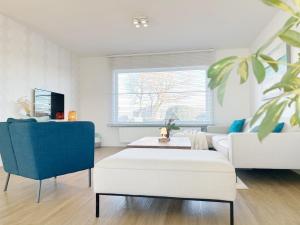 a living room with a couch and a table at Villa Duin 33 in Westende