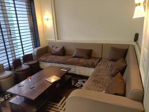 a living room with a couch and a table at Shree Guru Ashray in Ujjain