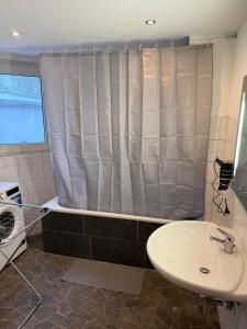 a bathroom with a shower curtain and a sink at Praktische Monteurwohnung 2 Marl in Marl +14 photos