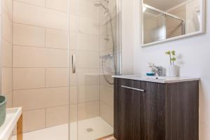 a bathroom with a shower with a sink and a mirror at Estudio Blaumar in L'Escala