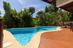 a swimming pool in a backyard with trees at Villa Vadee - Entire Private Villa, 4 Bedrooms, Large Swimming Pool, Ocean View in Thong Nai Pan Noi +32 photos