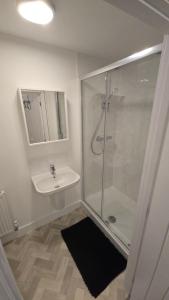 a bathroom with a shower and a sink at 3,Lime Tree Ave in Haverfordwest +11 photos