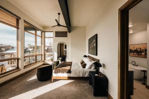 a bedroom with a bed and a large window at The Lookout in Winter Park