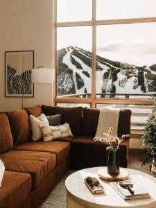a living room with a brown couch and a table at The Lookout in Winter Park +116 photos