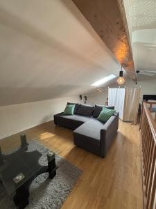 a living room with a couch and a table at Oniris - Parenthèse urbaine in Mont-de-Marsan