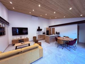 a living room with a couch and a table at villa'nduzienne in Anduze