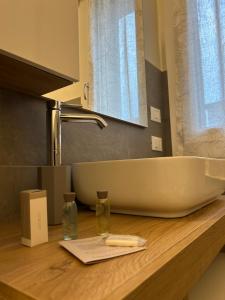 a bathroom sink on a wooden counter top with a sink at B&B Bozzini's Nest in Bagnolo San Vito +58 photos