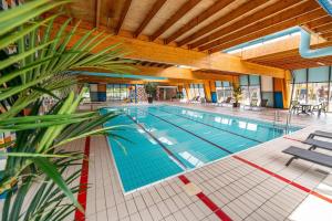 a large swimming pool in a large building at Ferienhaus Breskens in Breskens
