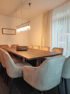 a dining room with a wooden table and chairs at das Alpenblick & Outdoor Lodge Nauders in Nauders