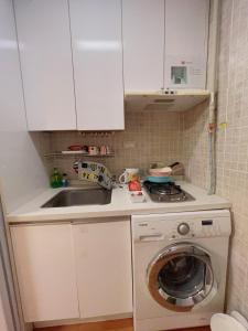 a kitchen with a washing machine and a sink at Whouse-sinchon in Seoul