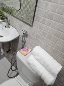 a bathroom with a white toilet and a sink at Sunset Senegal in Rufisque +35 photos