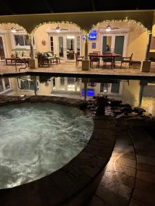 a large pool of water in a house with lights at Villagoona in Cape Coral